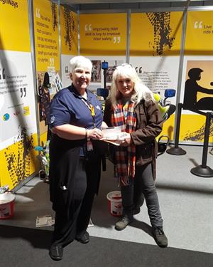 Treasurer Kate gives our donation to the DocBike charity